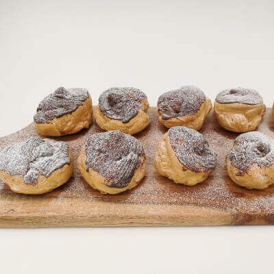 Chocolate dipped profiteroles filled with fresh cream